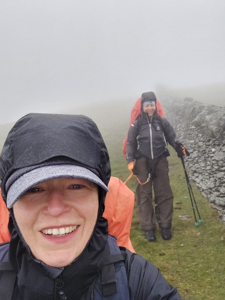 Heavy fog and low visibility obscuring the high grassy ridge line between Y Llethr and Diffwys.