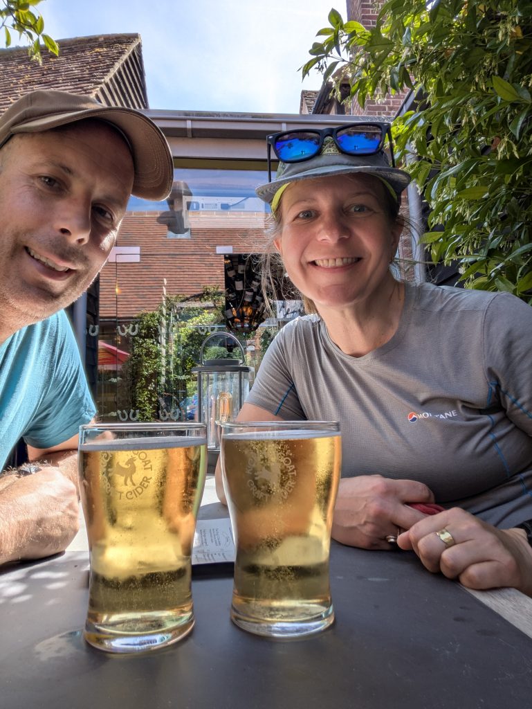 A cold, refreshing pint of cider resting on a wooden pub table.