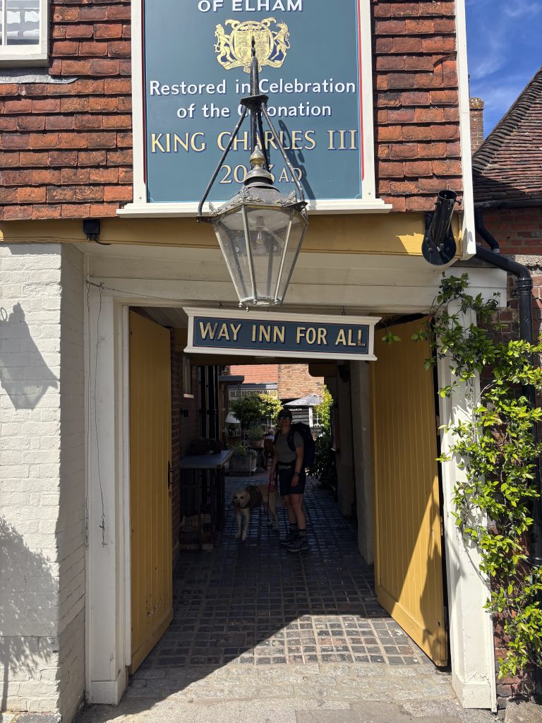The classic brick exterior and welcoming pub sign of The Kings Arms in the village of Elham.