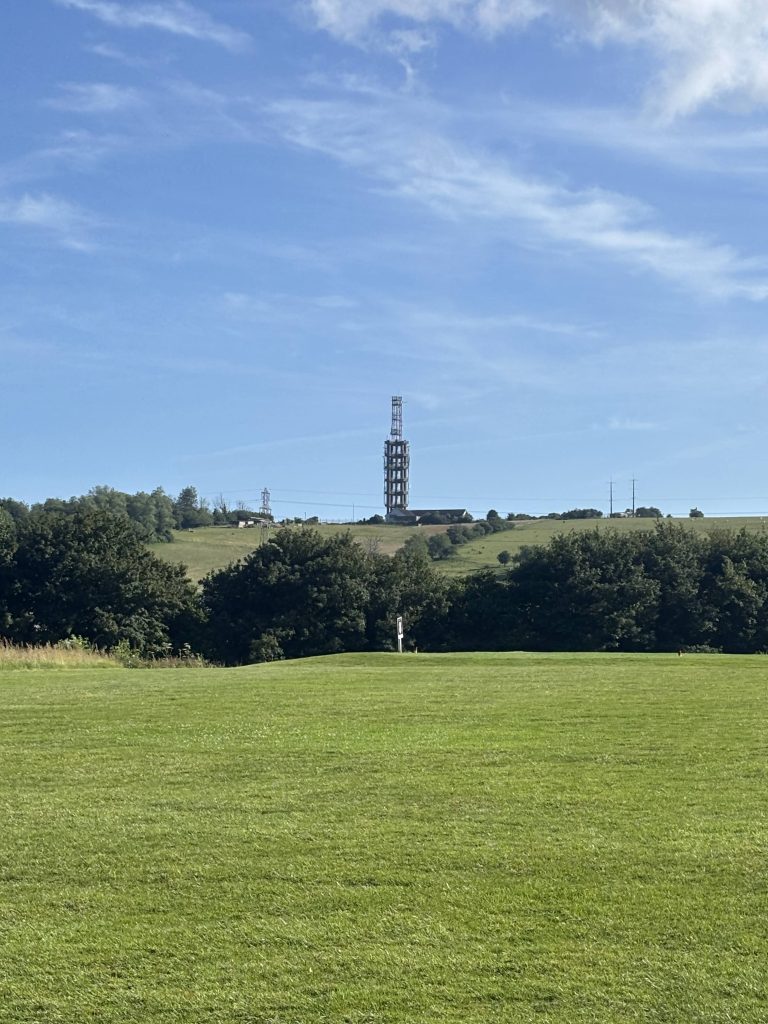 A towering metal radio mast standing at the summit of Etchinghill.