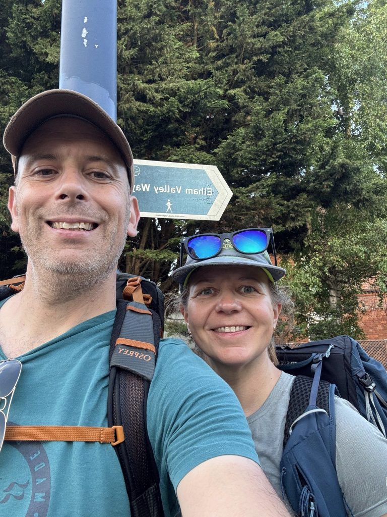A selfie of two tired but smiling hikers nearing the end of their 25-mile trek.