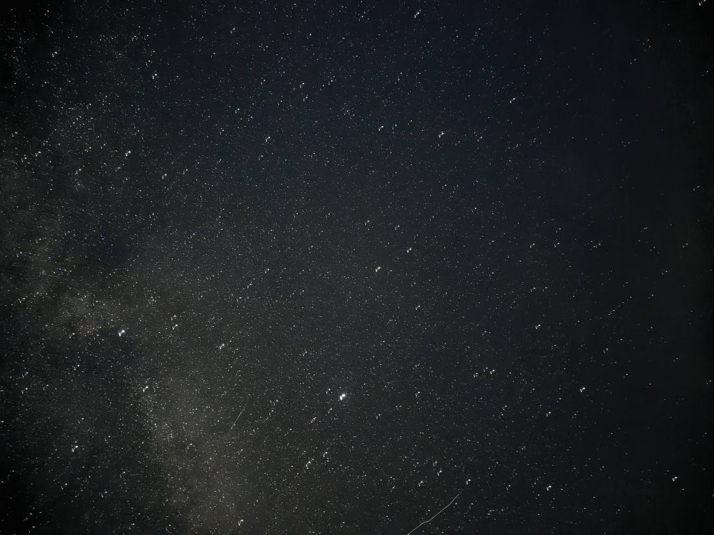 High-altitude night sky photography showing dense star fields and the Milky Way core above an unpolluted Dartmoor horizon.