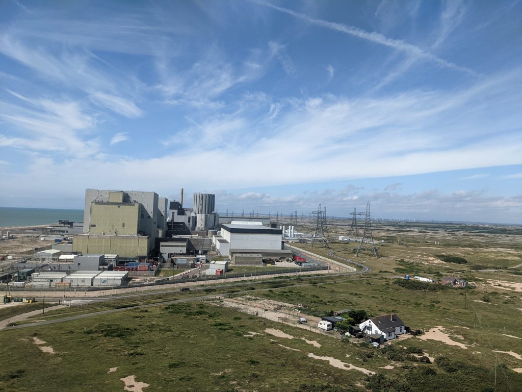 The massive brutalist concrete structures of the Dungeness B Nuclear Power Station overlooking the shingle.